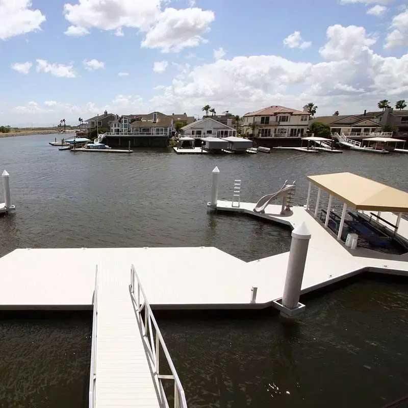 Open white dock with slide and boat parking